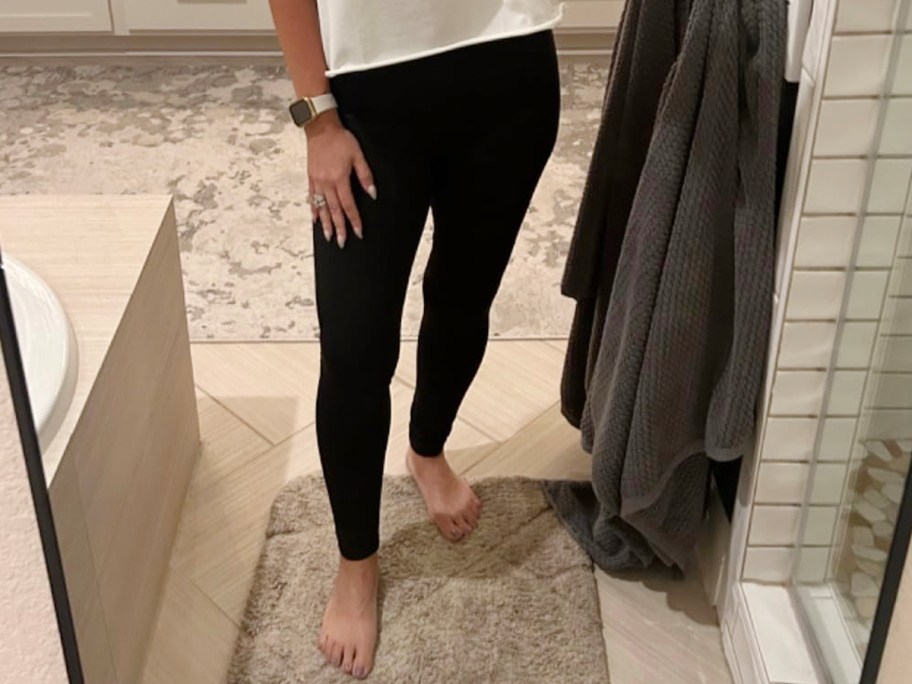 woman wearing black leggings and white tee