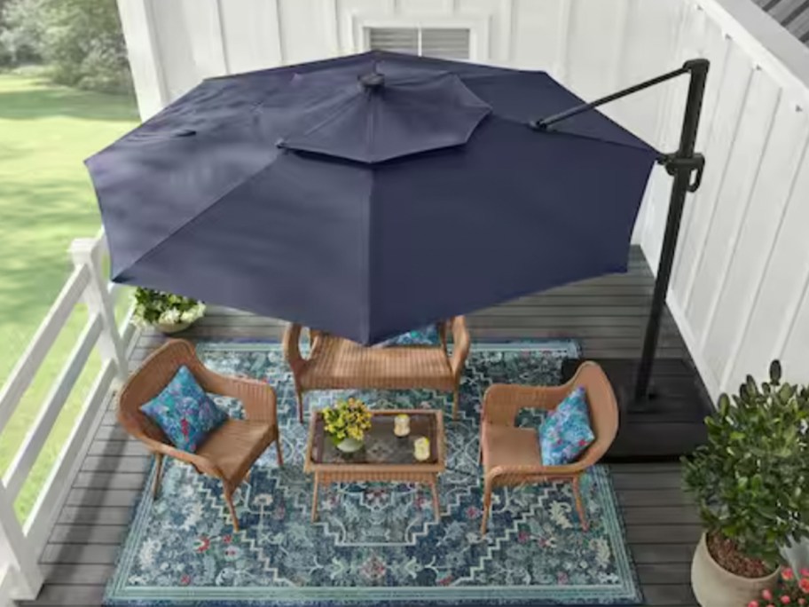 blue outdoor umbrella over patio set 