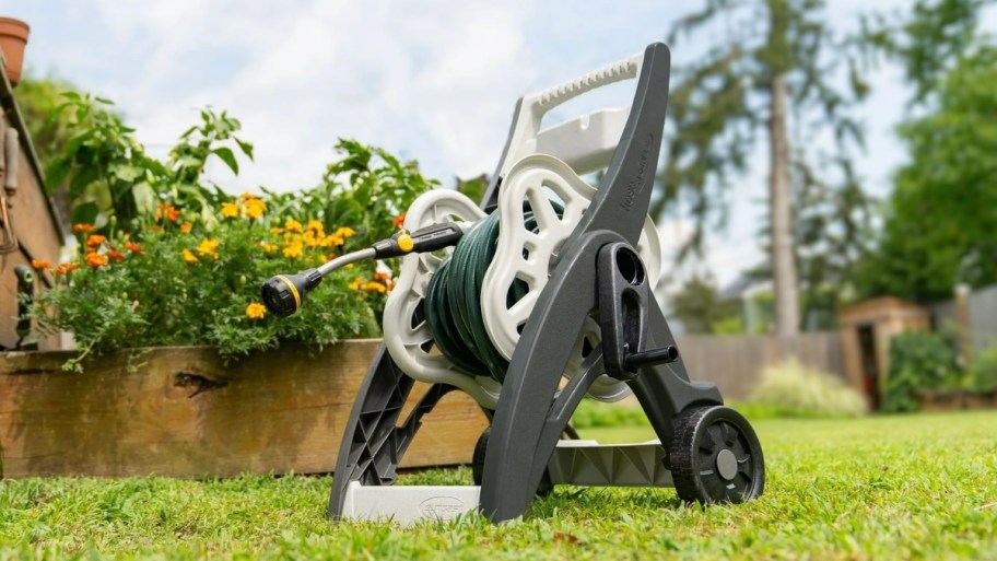 hose caddy in the grass next to a house