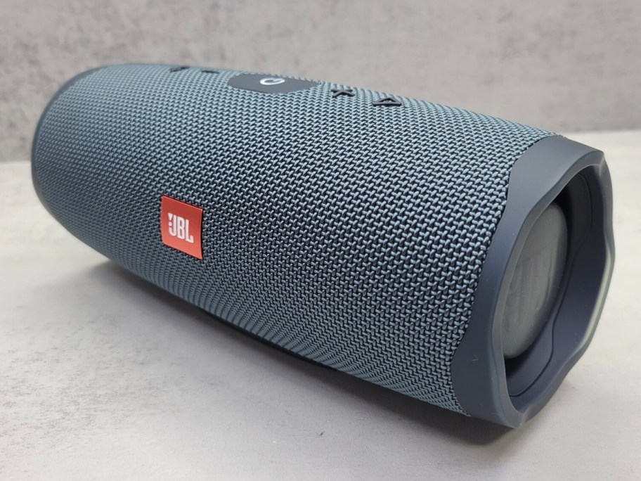 gray jbl speaker on table