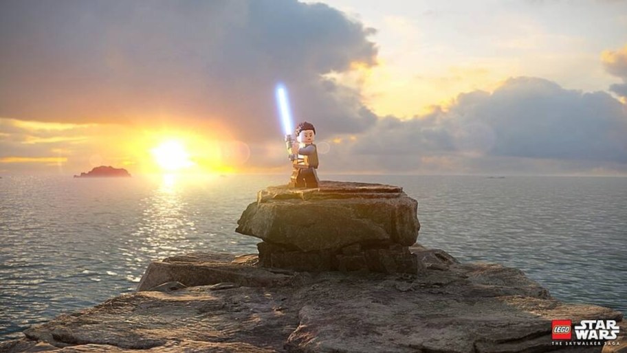 lego action figure holding light saber on rock