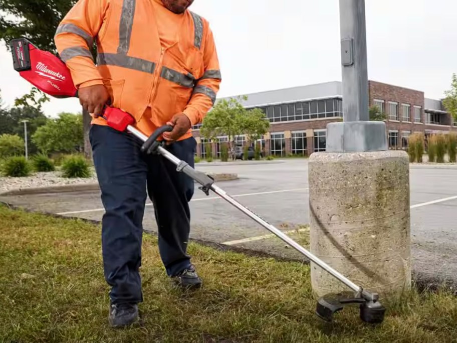 man using milwaukee trimmer 