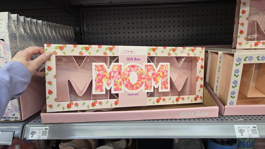 hand holding mom gift box on store shelf