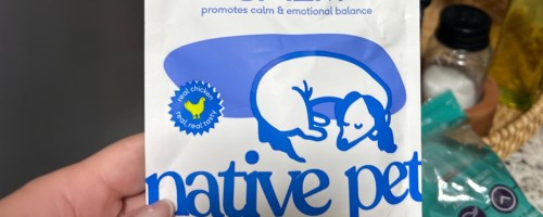 person holding bag of native pet calming dog chews