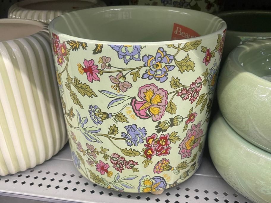 Beautiful Sage Wildflower Footed Ceramic Planter on shelf in store