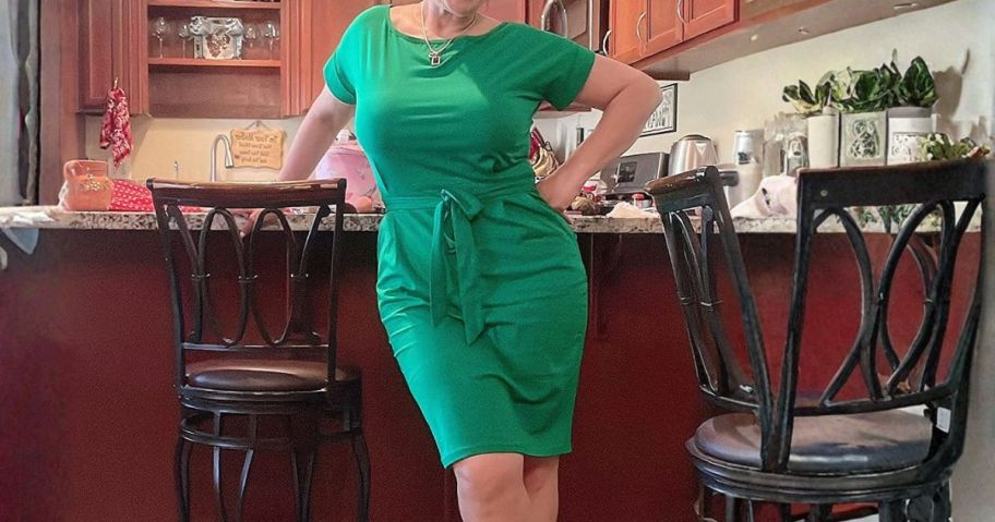 woman wearing green tie dress in kitchen