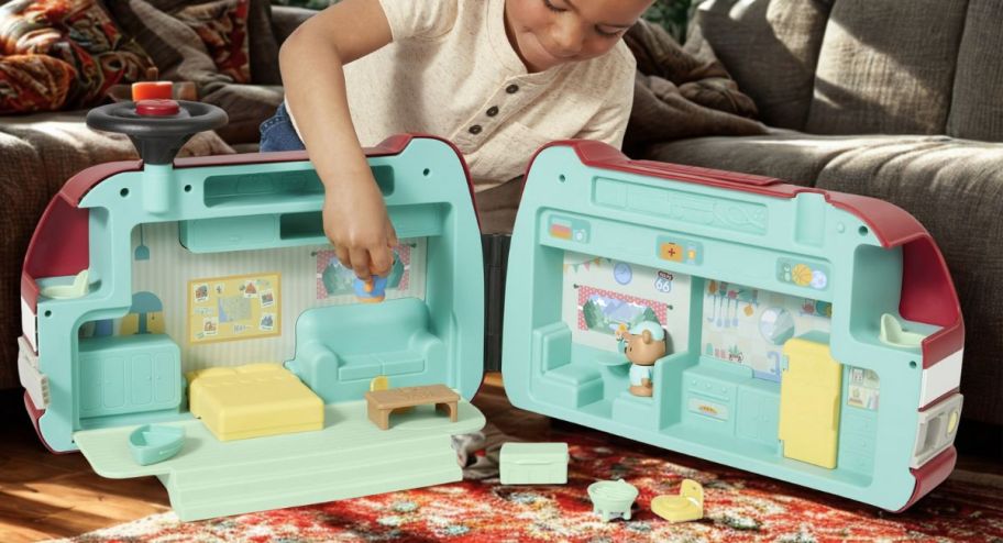 child playing with the ride on in his living room