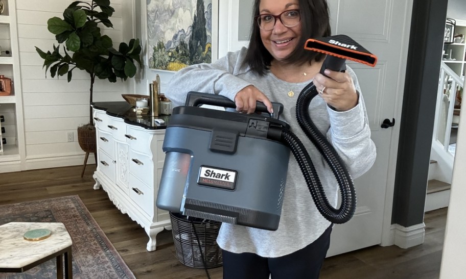 woman holding shark messmaster vacuum