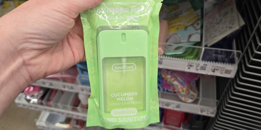 hand holding cucumber melon hand saniziter