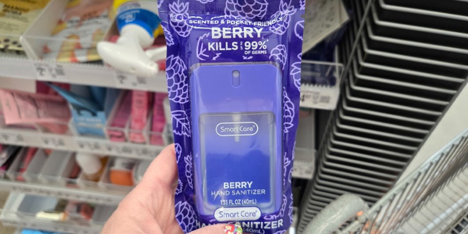 hand holding berry hand sanitizer