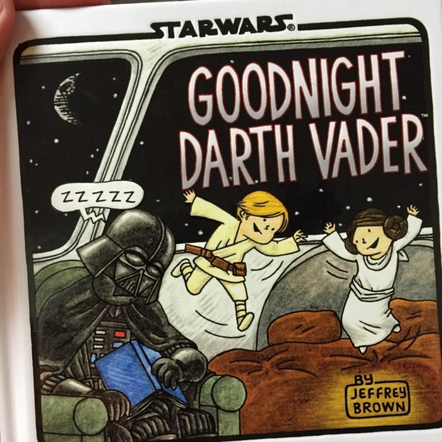 holding a Star Wars children's book