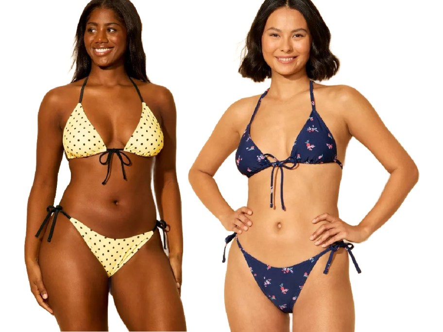 Two women modeling bikinis; the first wears a yellow polka dot bikini, the second a navy floral one.
