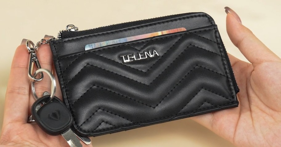 person holding black telena rfid wallet