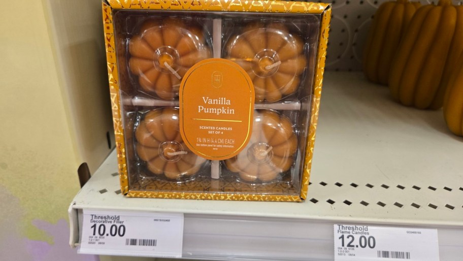 mini pumpkin shaped candles in box on store shelf
