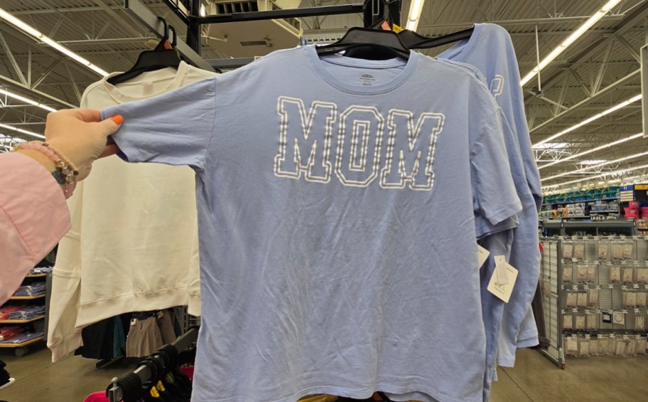 hand reaching for blue mom tee