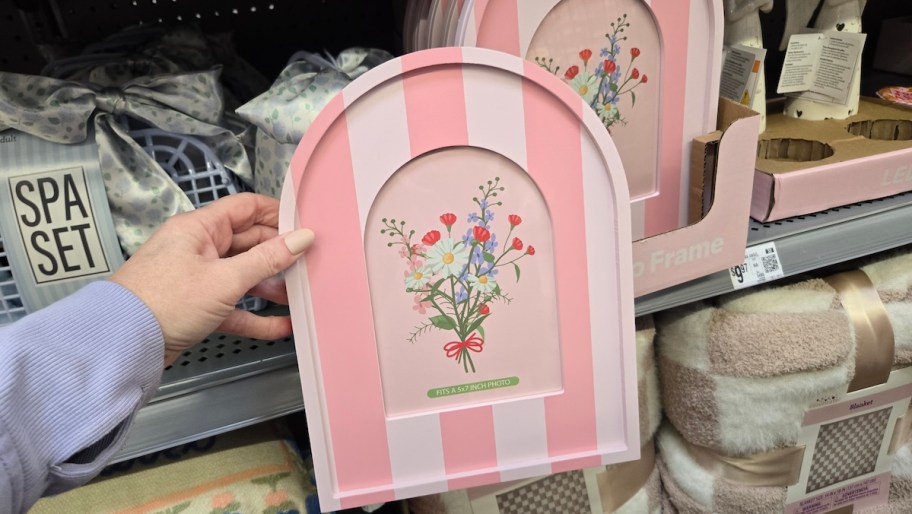 hand holding pink stripe picture frame