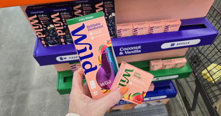 Hand holding Wild deodorant packaging labeled 