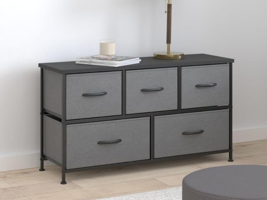 a grey and black 5 drawer fabric dresser