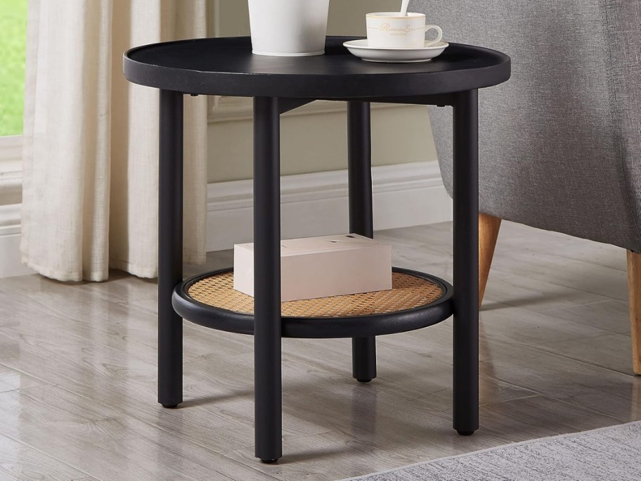 a round black wood and rattan side table 