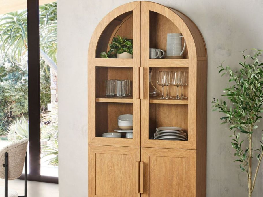 arched cabinet with covered bottom draw and showcased china