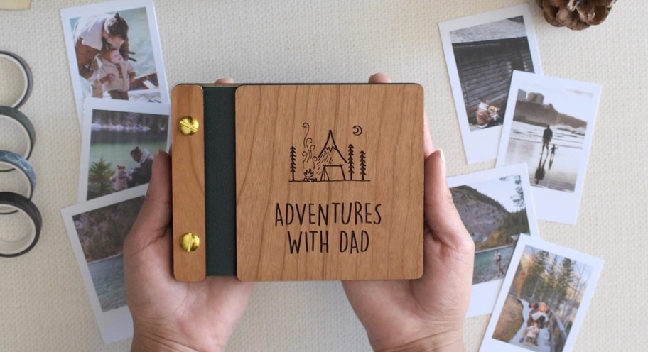 hand holding wooden adventures with dad photo book