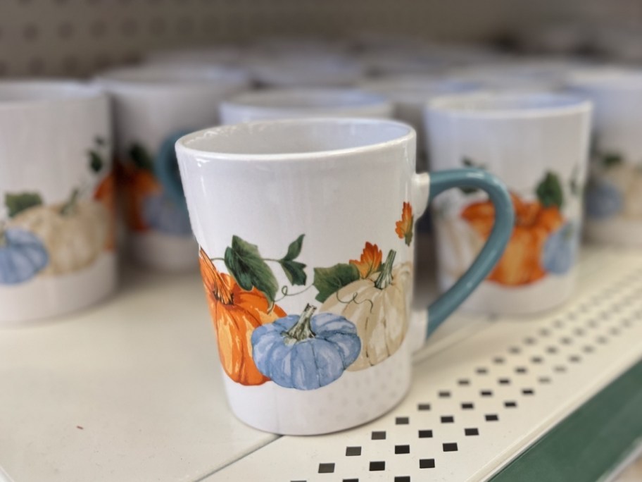 ceramic coffee mug with fall pumpkins on dollar tree shelf