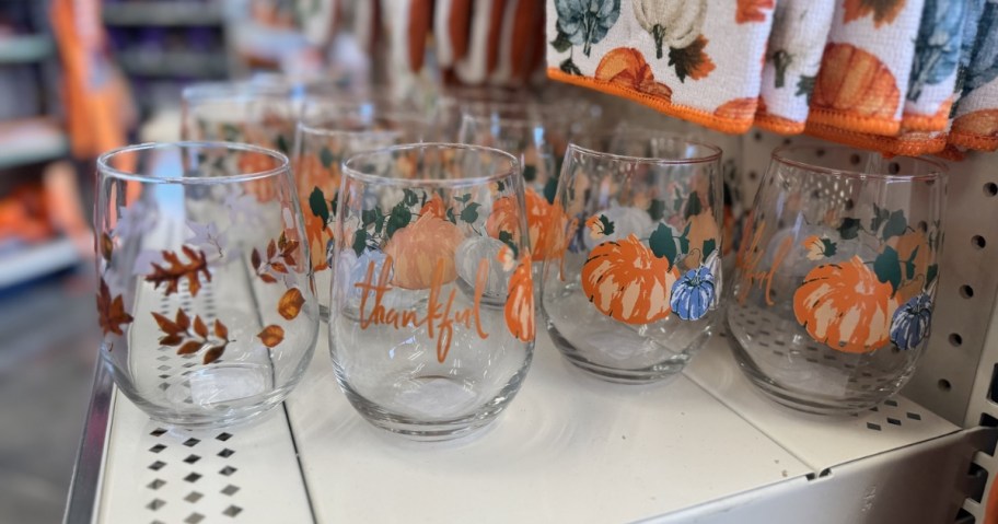 stemless wine glasses with fall themes on dollar tree shelf