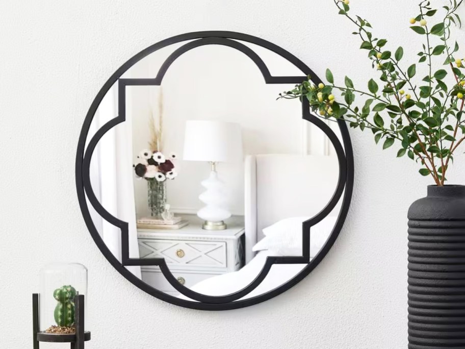 round black framed mirror on a wall