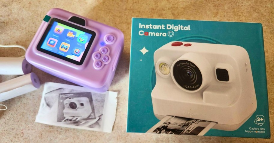 a kids instant print digital camera, the box it comes in, and a picture it printed