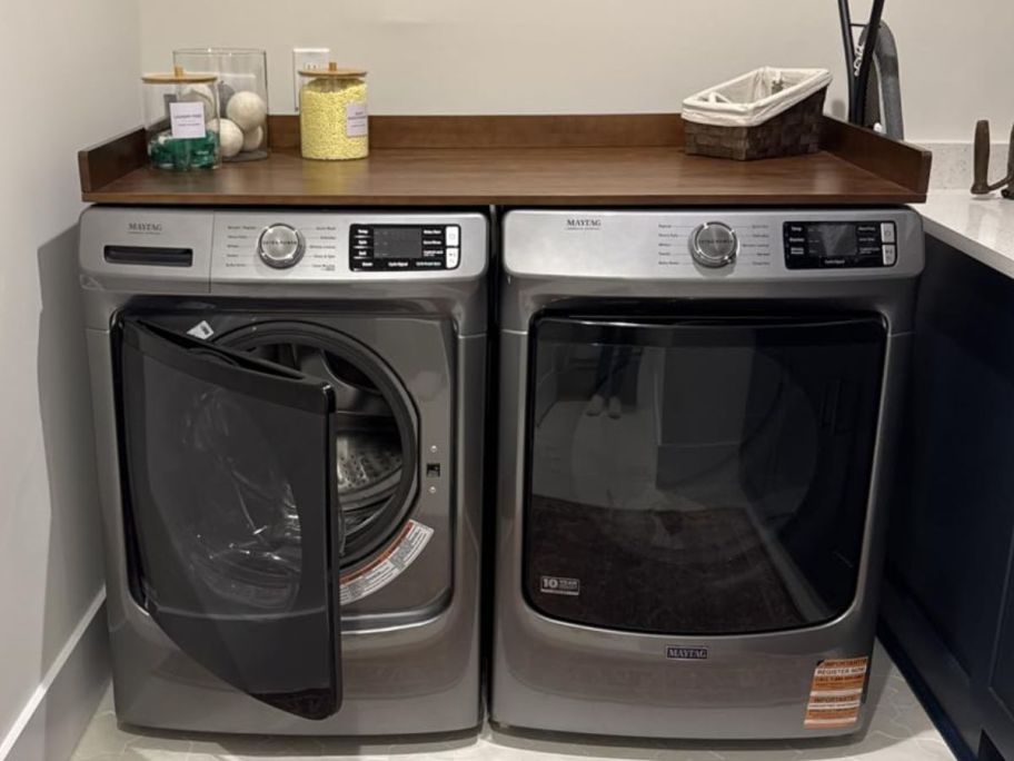 A washer and Dryer with a Retro Brown countertop on it