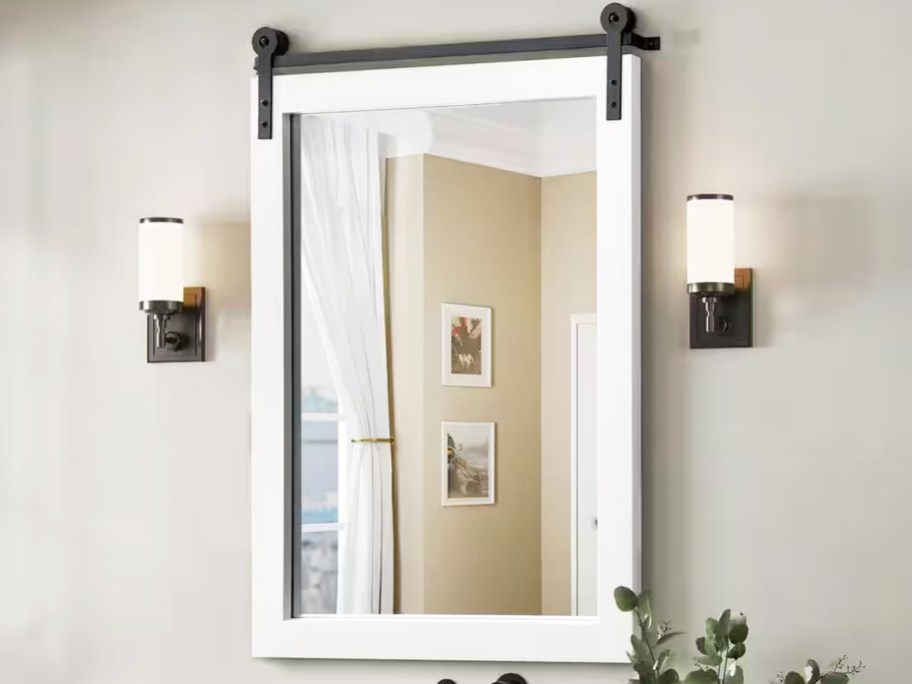 white wood framed mirror in bathroom