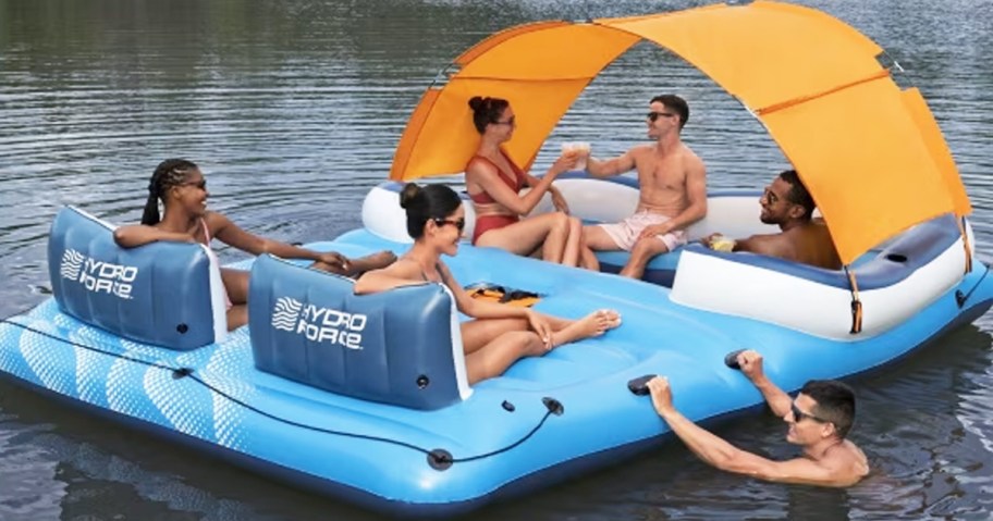 people hanging out on a blue and orange inflatable island in lake