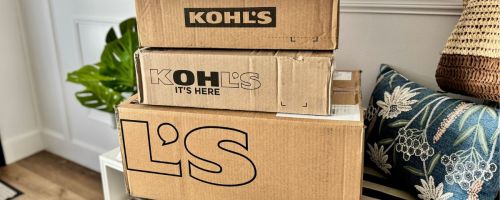 kohl's boxes stacked on bench in entryway