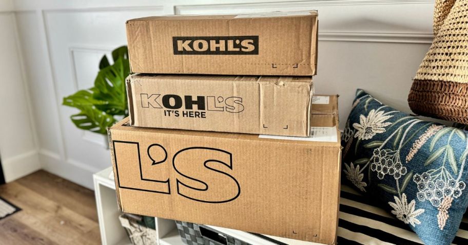 kohl's boxes stacked on bench in entryway