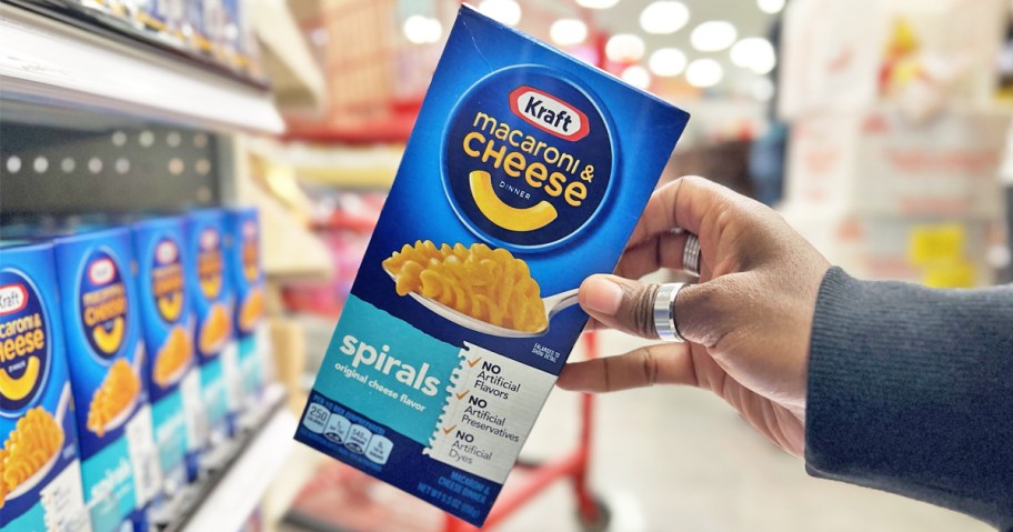 hand holding up a box of Kraft Mac & Cheese Spirals in store