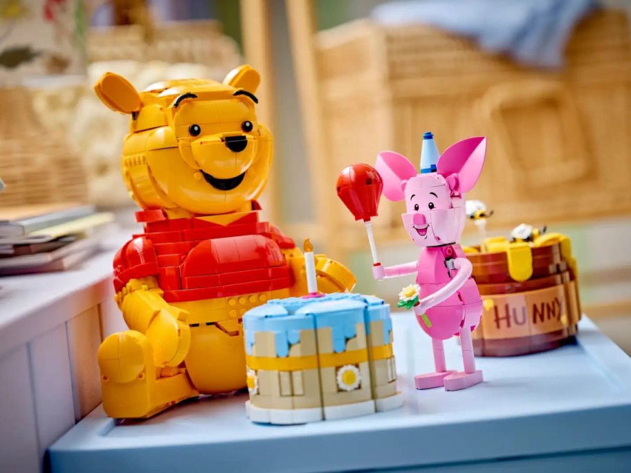 Complete Winne the Pooh and Piglet LEGO sets on a table.