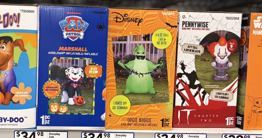 paw patrol, oogie boogie, and pennywise halloween inflatable boxes on store shelf