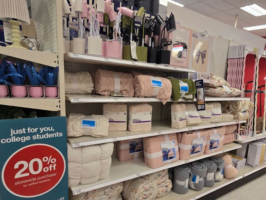 Aisle of dorm essentials with bedding, desk lamos, and mirrors at Target