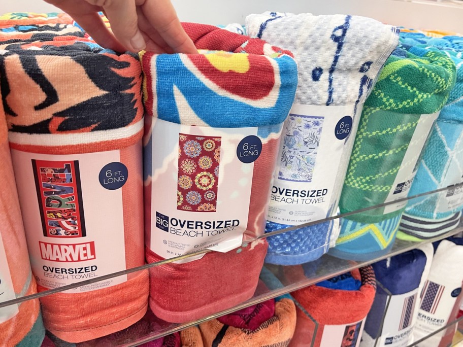 hand touching display of beach towels in kohl's