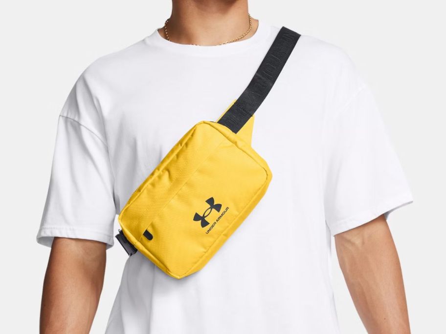 A person wearing a yellow crossbody belt bag