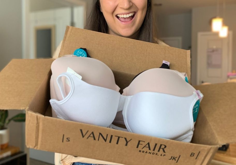 woman holding a box with vanity fair bras inside