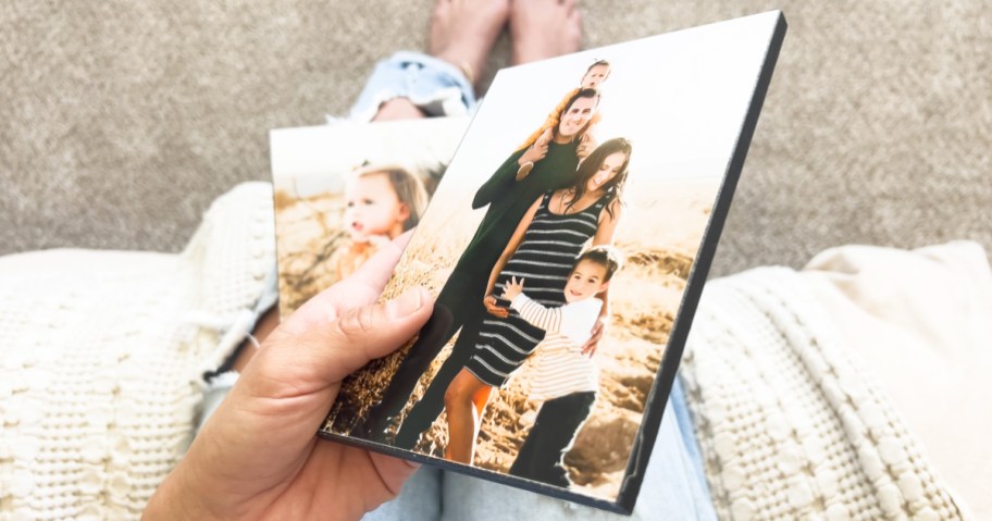 womans hand holding a wood photo panel