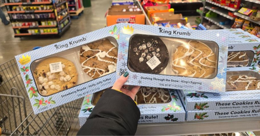 A person holding up 2 boxes of Walmart King Krumb Cookies