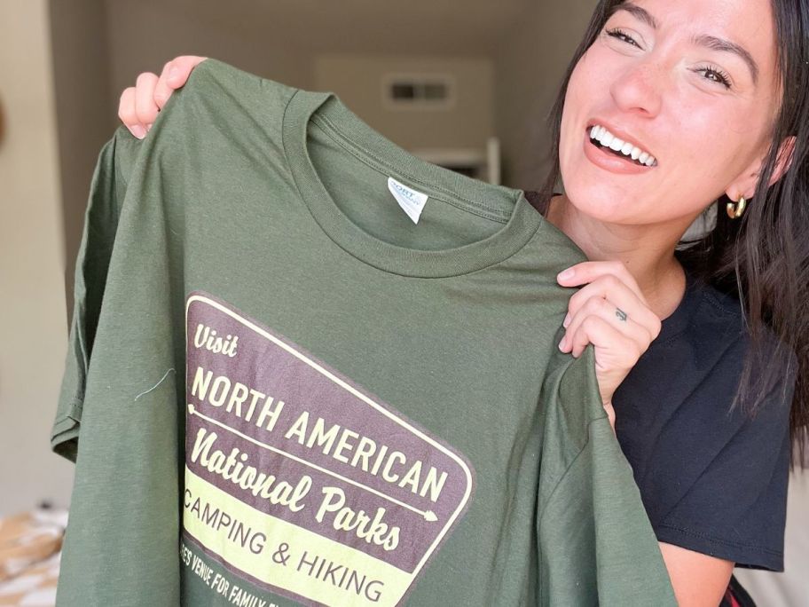 Woman holding a t-shirt from woot