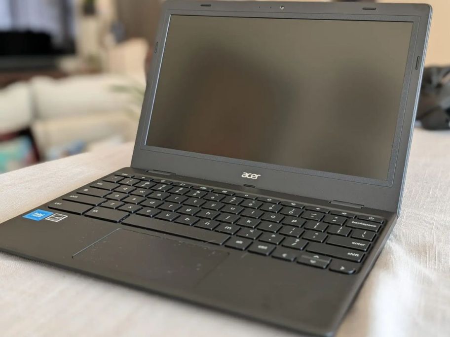 black acer laptop displayed on top of the table