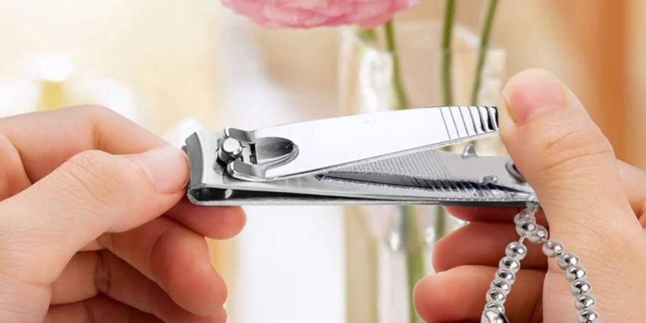 hands using nail clippers