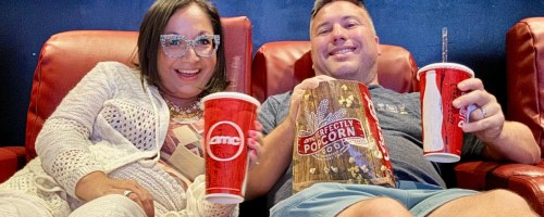 woman and man sitting in an amc theater