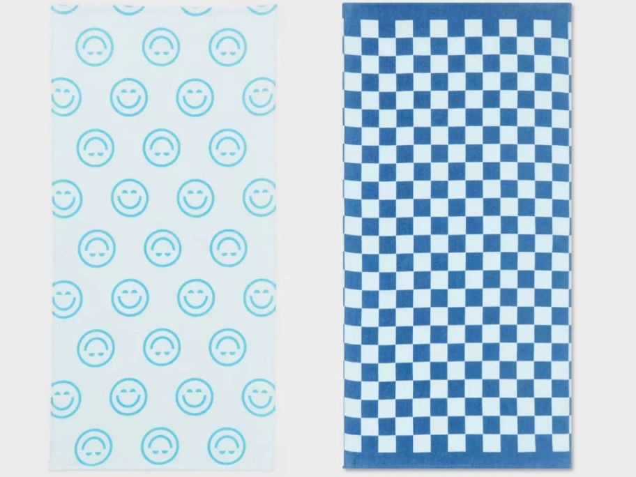 a blue smiley face and blue checkered sun squad beach towel