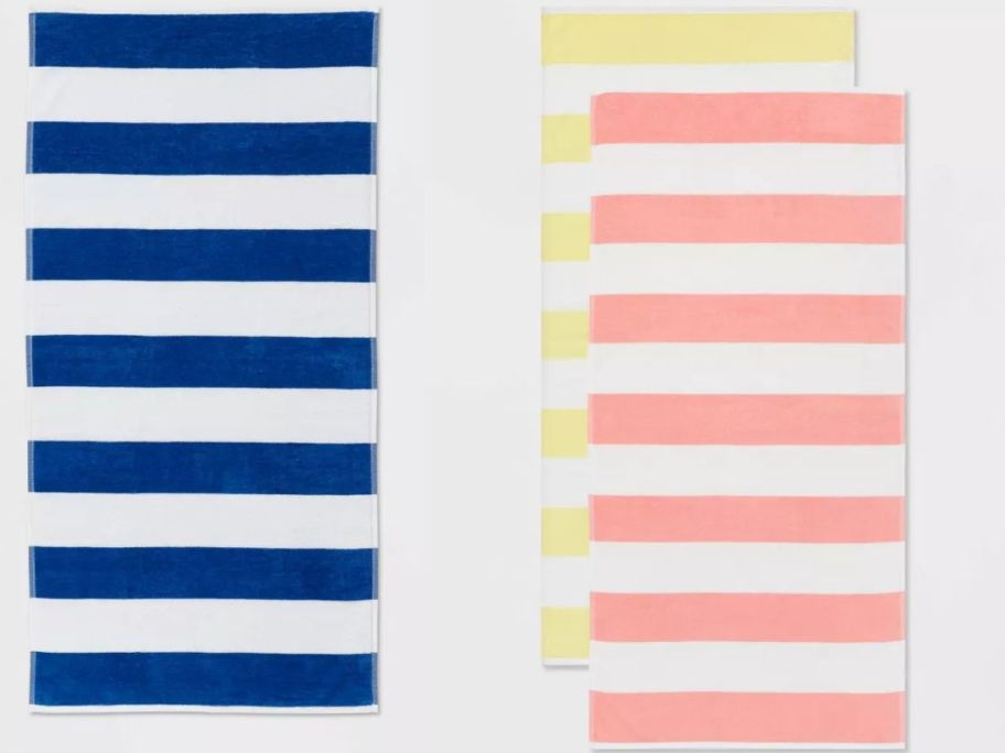 a blue and white Sun Squad Striped Beach Towel and two yellow and white and pink and white Sun Squad Striped Beach Towels