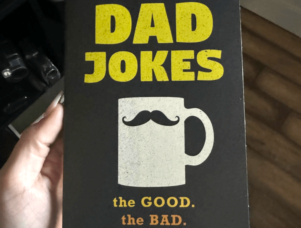 holding Dad Jokes book